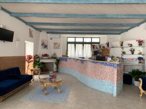a living room with a couch and a table at Residence Hotel Monte Ricciu Nuova Gestione in Alghero