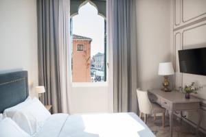 Un pat sau paturi într-o cameră la Palazzetto Foscari
