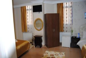 a bedroom with two beds and a television on the wall at Lotus Hotel in Istanbul