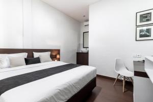 Postel nebo postele na pokoji v ubytování Kak Garden Inn