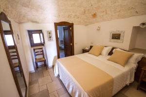 a bedroom with a large bed in a room at Il Palmento Hotel Relais in Locorotondo