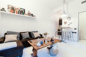 a living room with a couch and a table at Giovio Loft - The House Of Travelers in Como