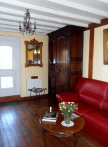 a living room with a red couch and a table at Welcome in Authuille