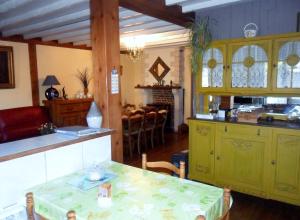 a kitchen with green cabinets and a table in a room at Welcome in Authuille +49 photos