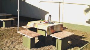 a picnic table with two benches and a sink at Duplex del Sol in Villa Carlos Paz