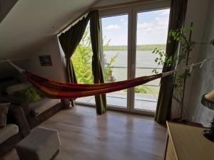 a hammock in a room with a large window at Gardos riverview in Belgrade