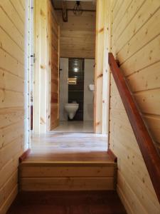 a staircase leading to a bathroom in a wooden cabin at Domki letniskowe KAMA Polańczyk 514-280-102 in Solina