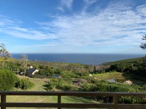 a view of the ocean from a house at Trinity Farm Ocean view Cottage in Plettenberg Bay