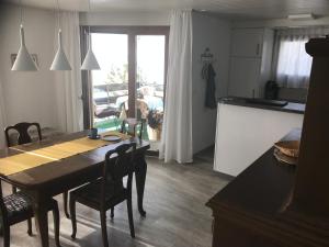 a kitchen and dining room with a table and chairs at Sonnastuba in Wildhaus