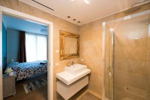 a bathroom with a sink and a shower at Bed & go Trento in Trento +29 photos