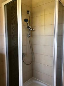 a shower with a shower head in a bathroom at Zakątek in Porąbka