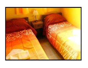Una cama o camas en una habitación de Cabañas Haras de Cuyo