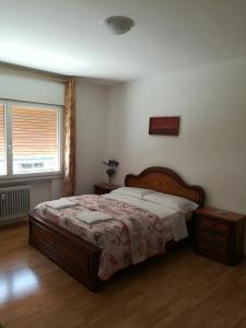 a bedroom with a large bed and a window at Venice Vacation House in Marghera