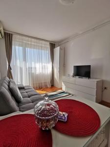 a living room with a couch and a bowl on a table at Central View Apartment in Timişoara