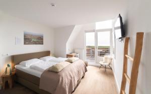 Postel nebo postele na pokoji v ubytování Het Vlielandhotel