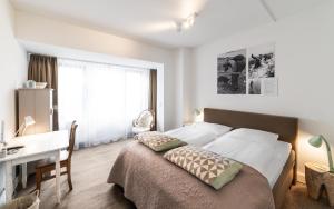 Postel nebo postele na pokoji v ubytování Het Vlielandhotel