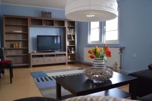 a living room with a vase of flowers on a table at Landidyll in Uelzen