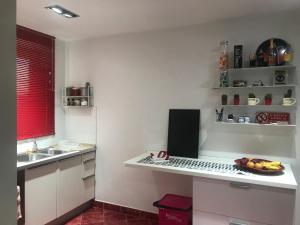 a kitchen with a desk with a laptop on it at Impero 6 in Scauri