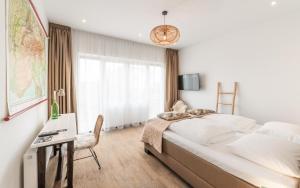 Postel nebo postele na pokoji v ubytování Het Vlielandhotel