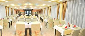 a banquet hall with white tables and white chairs at Hotel Beograd - Yu in Sarajevo