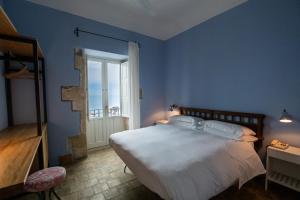 a blue bedroom with a large bed and a window at Hotel Gutkowski in Syracuse