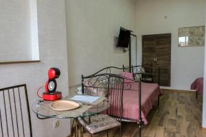 a bedroom with a bed with a glass table and a tableablish at 3 Studio in Tbilisi City