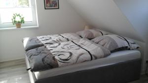 a bed with a blanket on it in a room at Pension Stahlberg in Lübz