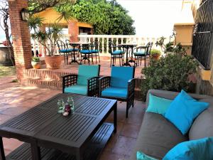 
a living room filled with furniture and a patio at Cortijo Amaya in Torrox Costa
