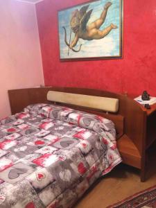 sypialnia z łóżkiem i zdjęciem na ścianie w obiekcie la casa di laura w mieście Calascibetta
