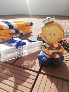 a toy sailor figurine sitting on a table with a syringe at Apartment Carpe Diem in Crikvenica