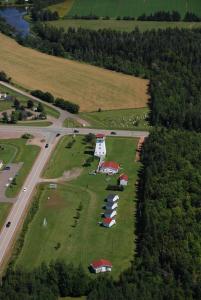 an aerial view of a large field with houses and a road at Baywatch Lighthouse Cottages & Motel in Brackley Beach