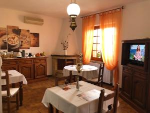 a dining room with two tables and a television at Carpe Diem in Olbia