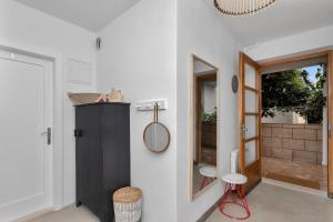 a bathroom with a black cabinet and a mirror at Apartments & Rooms Rica in Makarska