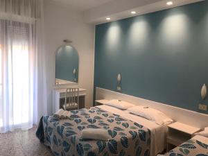 Postel nebo postele na pokoji v ubytování Hotel Vasco