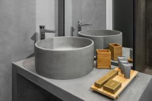 a bathroom with two sinks and two mirrors at La Maison Athenes in Athens +54 photos