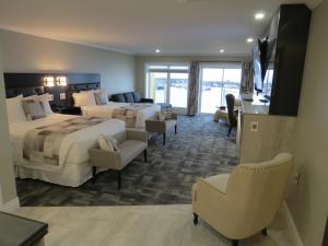 a hotel room with two beds and a living room at Dockside Suites in Digby