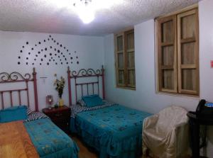 a room with two beds in a room at Escocie - Centro Historico in Quito