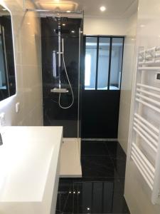 a bathroom with a shower with a glass door at Hôtel Le Mistral in Marseille