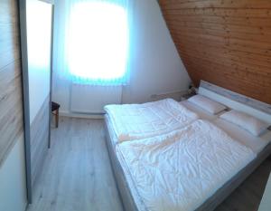 a bed in a room with a window at Weinbergblick in Ramsthal