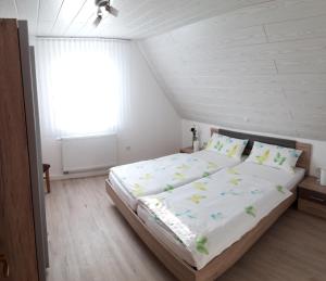 a bedroom with a large bed in a attic at Weinbergblick in Ramsthal
