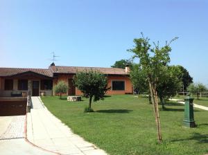 una casa con un patio con árboles delante de ella en Villa Pasini, en Provaglio d'Iseo