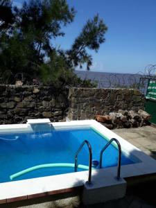 a swimming pool with a view of the ocean at Lago Merin in Lago Merin