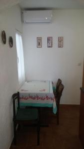 a room with a bed and a chair in it at Apartment Dante in Tisno