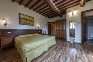 a bedroom with a large bed and a large window at Fonte Dei Tufi in Siena