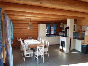 a kitchen and dining room with a table and chairs at Jafura LM in Liptovský Trnovec