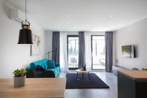 a living room with a blue couch and a table at Apartments Jadranka in Selce