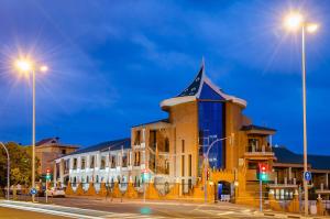 a building on a street at night with street lights at Hotel Boutique Calas de Alicante in Alicante