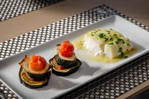 a plate with three different types of food on it at Hotel Boutique Calas de Alicante in Alicante