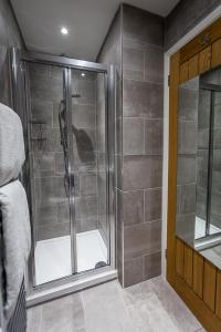 a shower with a glass door in a bathroom at BN2 Holiday Apartment in Brighton & Hove