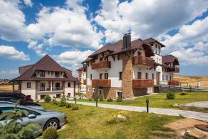 a large house with a car parked in front of it at Zlatibor Hills 31 in Zlatibor